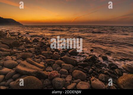 sunset over rocky shore at low tide on bay of fundy Stock Photo