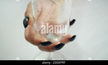 female hand holding a wine glass Stock Photo