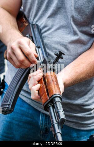 Florida Ft. Fort Lauderdale Beach Air & Sea Show,National Guard military weapons guns confiscated Afghanistan,man handles handling holds holding gun, Stock Photo
