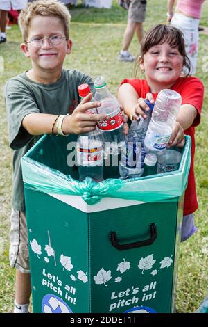 Ft. Fort Lauderdale Florida,boy girl kids children recycle bin,recycles recycling plastic bottles let's all pitch in Stock Photo