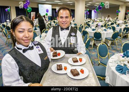 Miami Florida,Hyatt Regency hotel Hispanic waiter waitress server employee employees inside interior workers ballroom serving dessert, Stock Photo