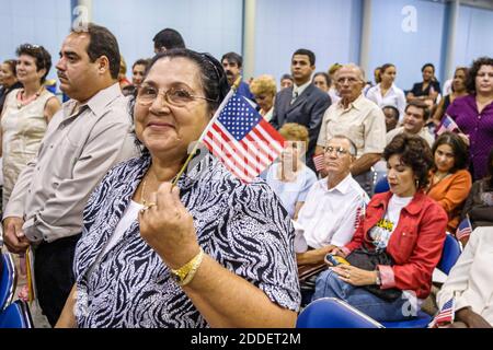 Florida,Miami Beach Convention Center,centre,naturalization ceremony oath of citizenship Pledge Allegiance,immigrant immigrants holding small miniatur Stock Photo