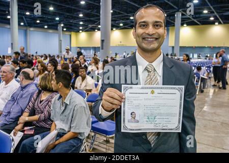 Florida,Miami Beach Convention Center,centre,naturalization ceremony oath of citizenship Pledge Allegiance,immigrant man new citizen,hold holding cert Stock Photo
