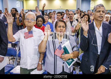 Florida,Miami Beach Convention Center,centre,naturalization ceremony oath of citizenship Pledge Allegiance,immigrants Asian women man senior recite re Stock Photo