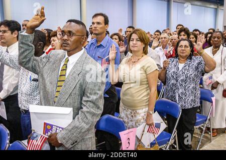 Florida,Miami Beach Convention Center,centre,naturalization ceremony oath of citizenship Pledge Allegiance,immigrants Black Hispanic women man recite Stock Photo