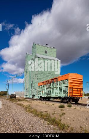 Railroad cattle car and grain elevators, Nanton, Alberta, Canada Stock Photo