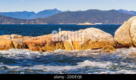 Seascape of the rocky shoreline and ocean waves in the West Vancouver Park BC/Canada. Selective focus, travel photo, nobody. Stock Photo