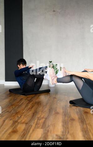 women engaged in strength and functional training in the studio. vertical photo Stock Photo