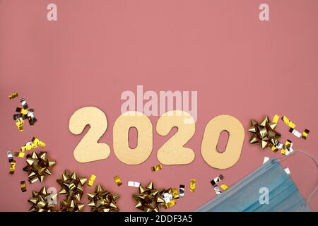 Number 2021 on pink background decorated with golden starry confetti. New Year celebration concept Stock Photo