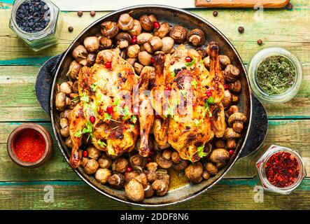 Roasted baked poult with mushrooms champignons on wooden table Stock Photo