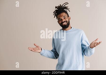 Happy african american guy posing with throwing up hands isolated over white background Stock Photo