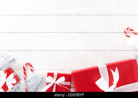 White and red Christmas theme background with gift boxes and decorating elements, top view Stock Photo
