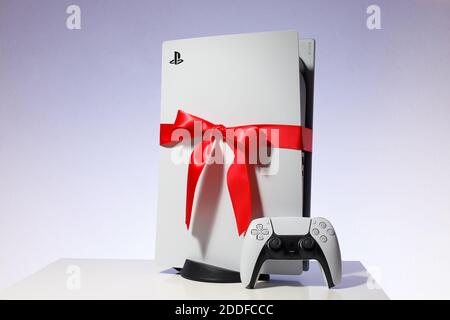 Sony PlayStation 5 game console on black background. Gift edition with red ribbon black friday and Christmas deal Stock Photo