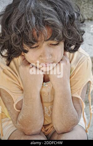 Poverty and poorness on the expression of children Stock Photo