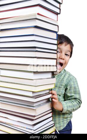 A big tower of many books vertical and kid hiding Stock Photo