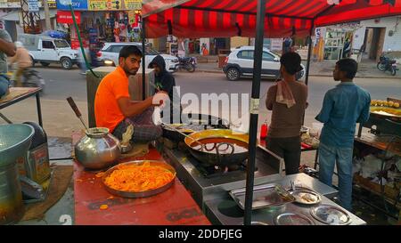 November 2020- Mahroli, Jaipur, India / Indian confectioner making sweet and crispy Jalebi.Delicious street side snack popular in India. Stock Photo