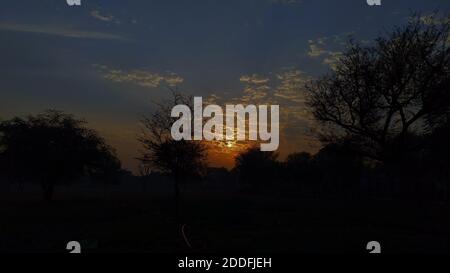 Colorful sun rays view in the evening time, sun hiding in sky. Stock Photo
