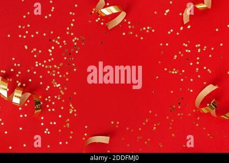 Golden swirls and sparkles on red background. Stock Photo
