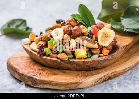 assorted dried fruits in wooden bowl. organic food background Stock Photo