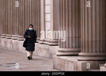 A pedestrian walks past the Bank of England, in London, Britain November 25, 2020. REUTERS/Simon Dawson