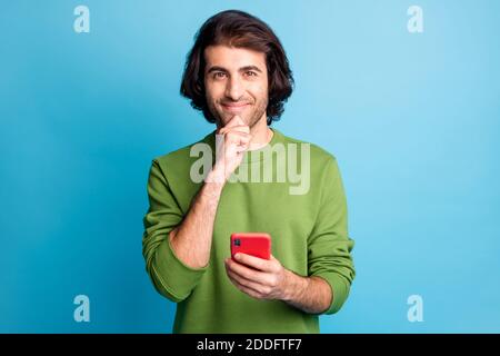 Portrait of nice blogger write curious about new comment wear sweater isolated on blue color background Stock Photo