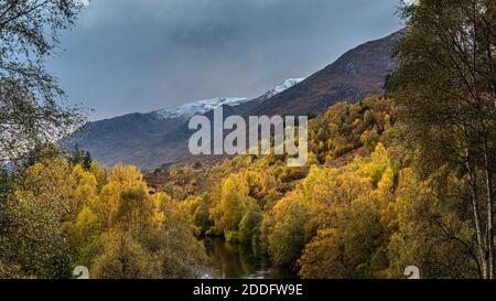 The autumn colours in Glen Affric in the Scottish Highlands with the first snows on the hills Stock Photo