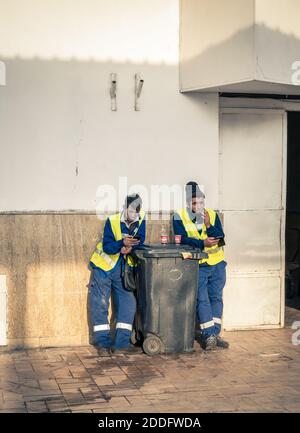 Bucharest/Romania - 11.16.2020: Workers or garbage man taking a cigarette and coffee break break Stock Photo