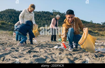 Young man cleaning the beach Stock Photo