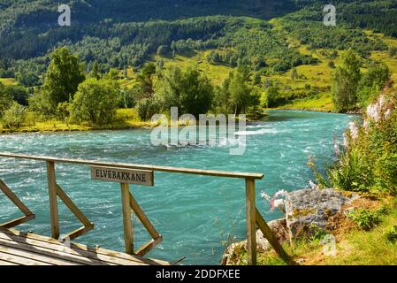 Wooden footbridge across a tributary of the Oldeelva River on the outskirts of Olden, Norway. Stock Photo