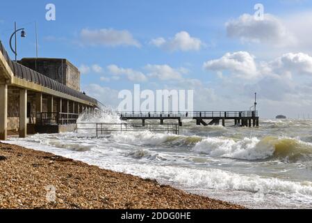 View along the seafront at Old Portsmouth, Hants, during a rough winter storm, with waves breaking against the seawall in front of the Square Tower. Stock Photo