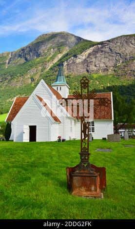 The Old Church in Olden, Norway, which was replaced by the New Church in 1934. A rusting iron cruciform is in the foreground. Stock Photo