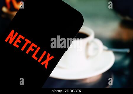 In this photo illustration a red Netflix content platform logo seen displayed on a smartphone. Stock Photo