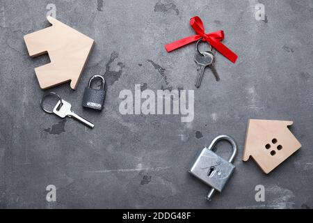 Keys from house and padlocks on dark background Stock Photo