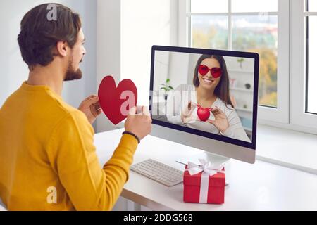 Couple in love having romantic online date on Saint Valentine's Day in quarantine Stock Photo