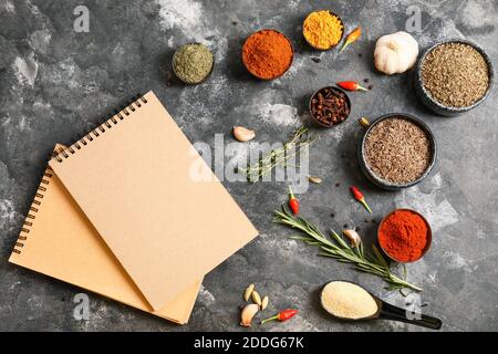 Notebooks for recipes and spices on grey background Stock Photo
