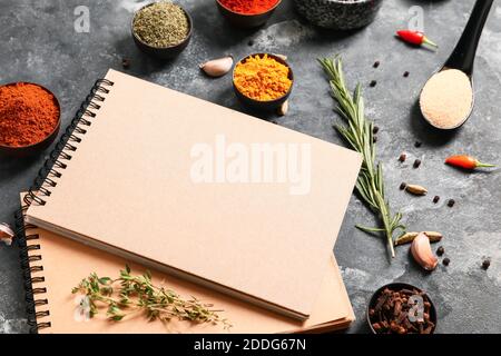 Notebooks for recipes and spices on grey background Stock Photo