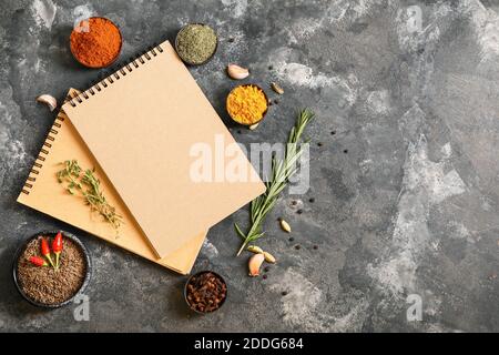 Notebooks for recipes and spices on grey background Stock Photo