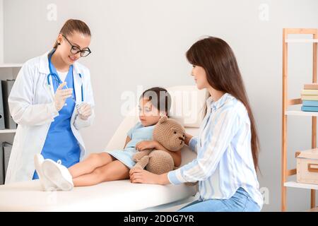 Doctor giving diabetic girl insulin injection in clinic Stock Photo