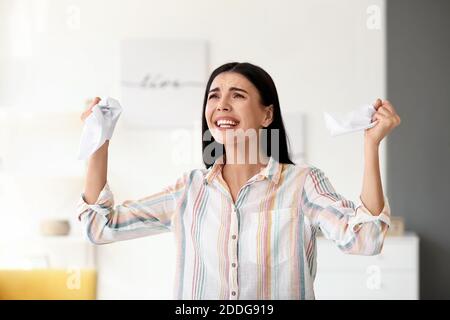 Stressed young businesswoman in office Stock Photo