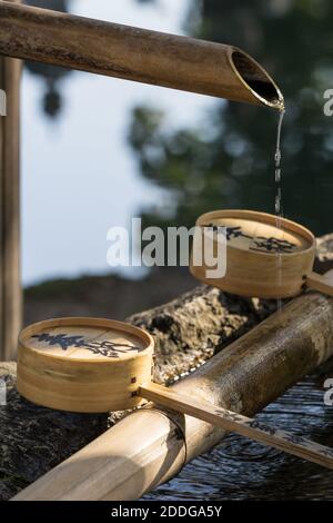 Close up detail of a chozubachi, 手水鉢, or water bowl, used to rinse the hands in Himuro Jinja shrine in Nara, Japan Stock Photo