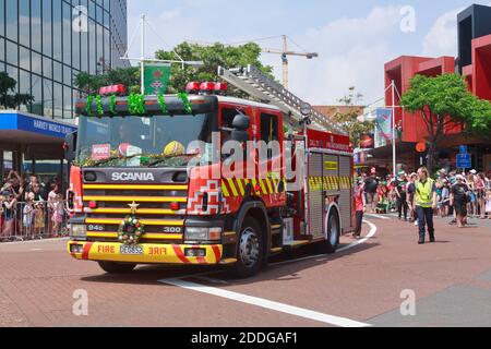 A fire truck decorated with tinsel and a wreath, taking part in a Christmas parade in Tauranga, New Zealand. November 30 2019 Stock Photo