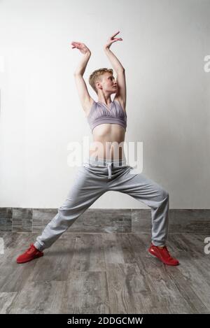 Woman in dance pose, arms raised Stock Photo