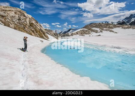 Climber photographing view, Bugaboo Provincial Park, British Columbia, Canada Stock Photo