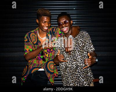 Front view of African American male friends in city at night Stock Photo