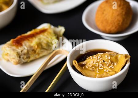 Top view of various tasty fusion food arranged on black table in restaurant Stock Photo