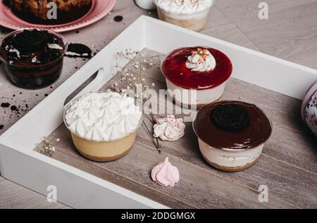 From above of chocolate cake and meringue cookies placed on table with desserts with whipped cream Stock Photo