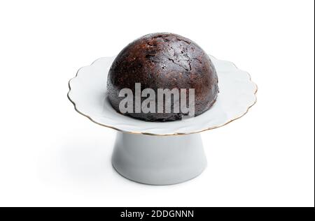 Traditional  festive christmas pudding on porcelain cake stand isolated on white Stock Photo