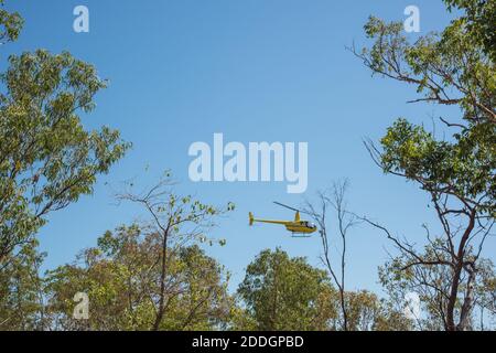 Darwin, NT, Australia-August 15,2018: Touring helicopter flying over the tree tops at Charles Darwin National Park in the Northern Territory Stock Photo
