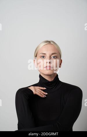 Stock photo of young female doctor taking notes in her video call with patient. Stock Photo