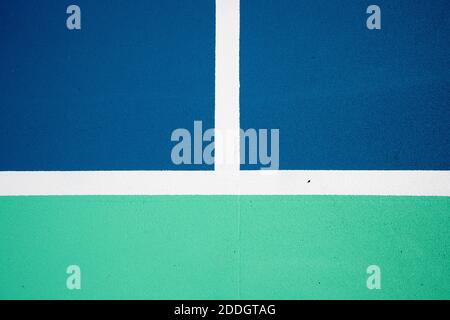 Full frame view over freshly painted royal blue and green tennis court with high contrasting white lines. Stock Photo